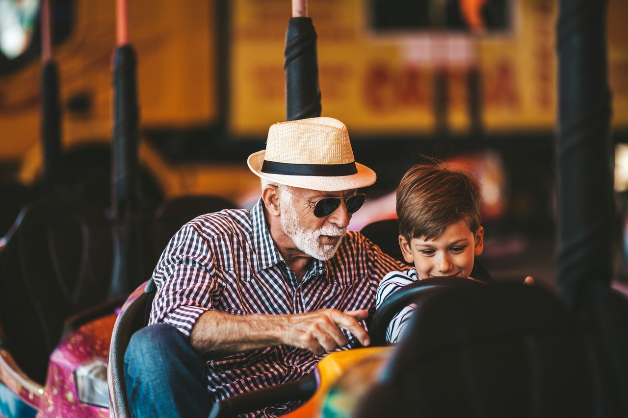 grandfather and son on ride